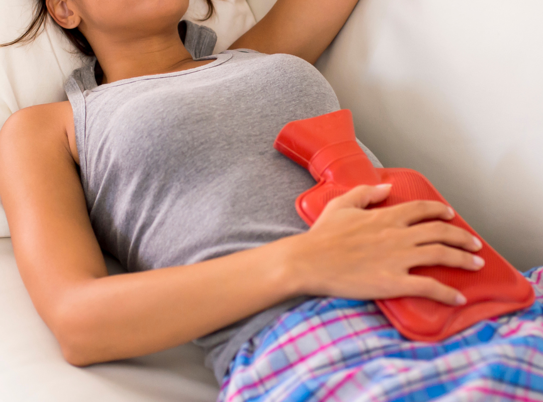 Photo of a woman using a hot water bottle