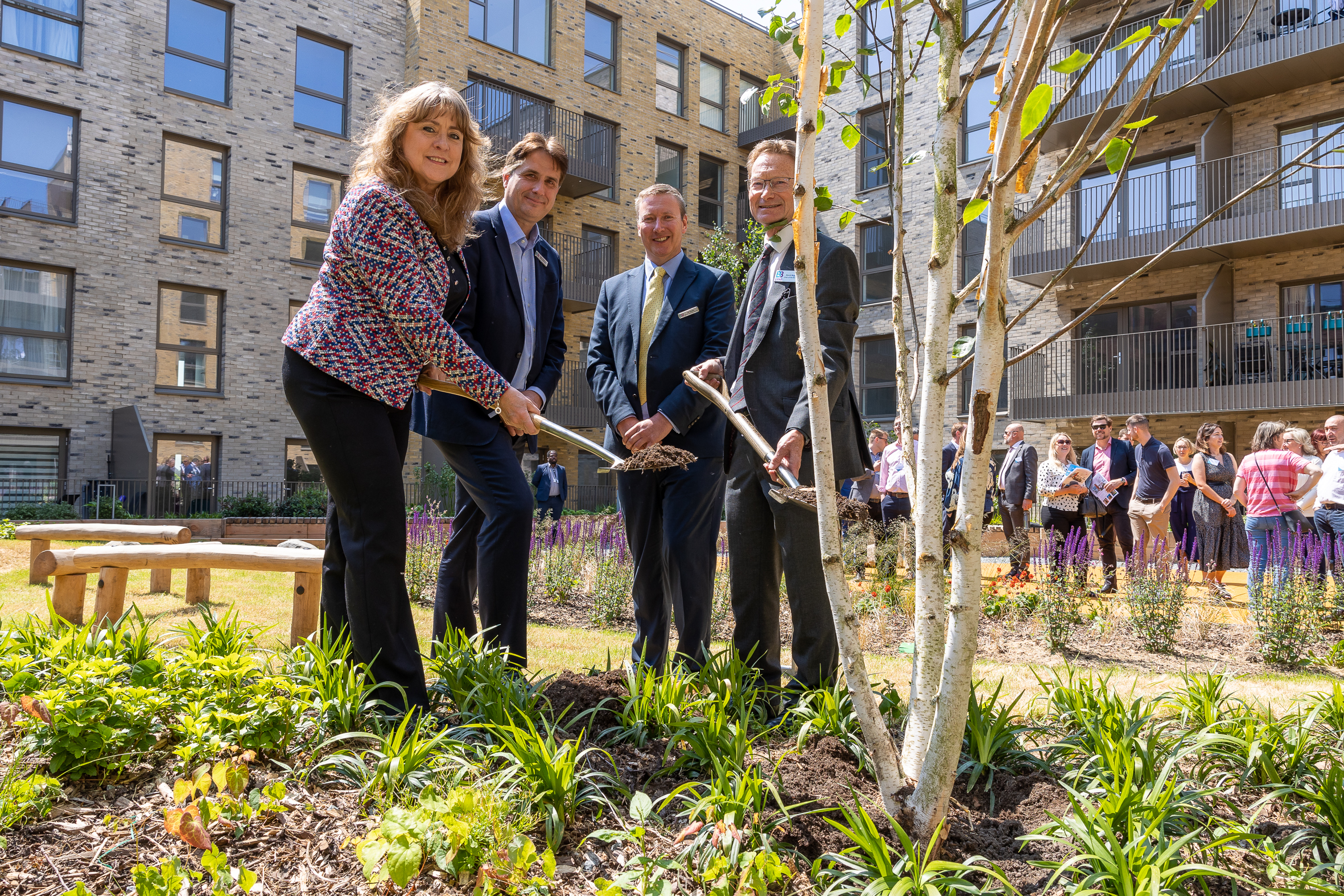 Photo of stakeholders from Homes England and B3Living planting a tree in the podium garden at Cheshunt Lakeside