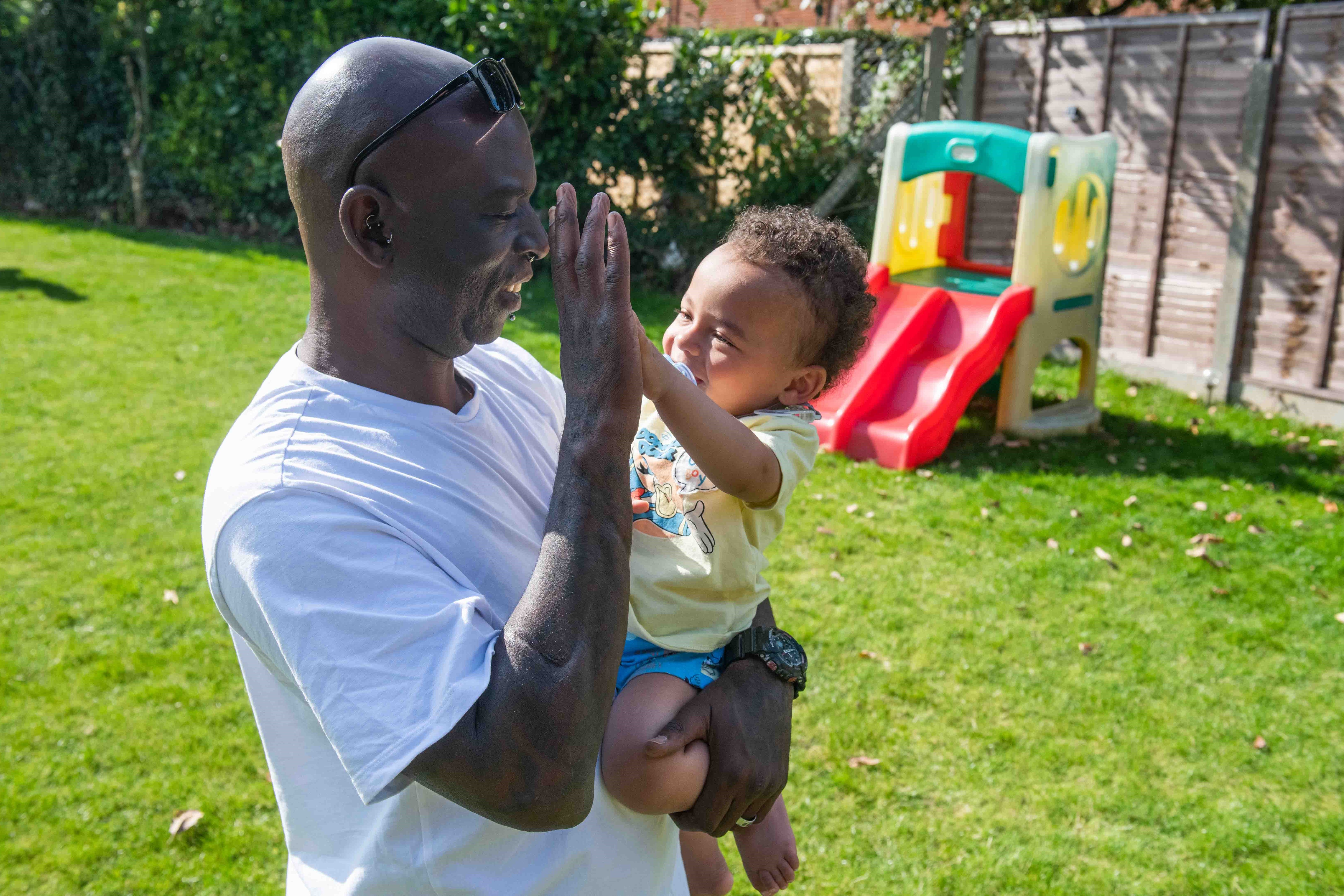 Photo of father and child in garden