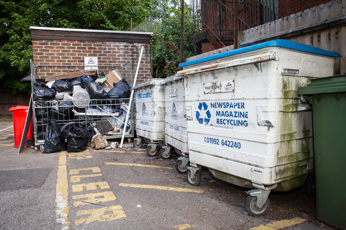 Image of waste by refuse bins - fly tipping