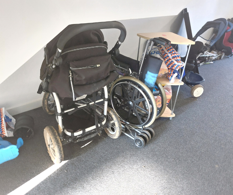 Photo of items left under stairs - buggies, wheelchair, bikes